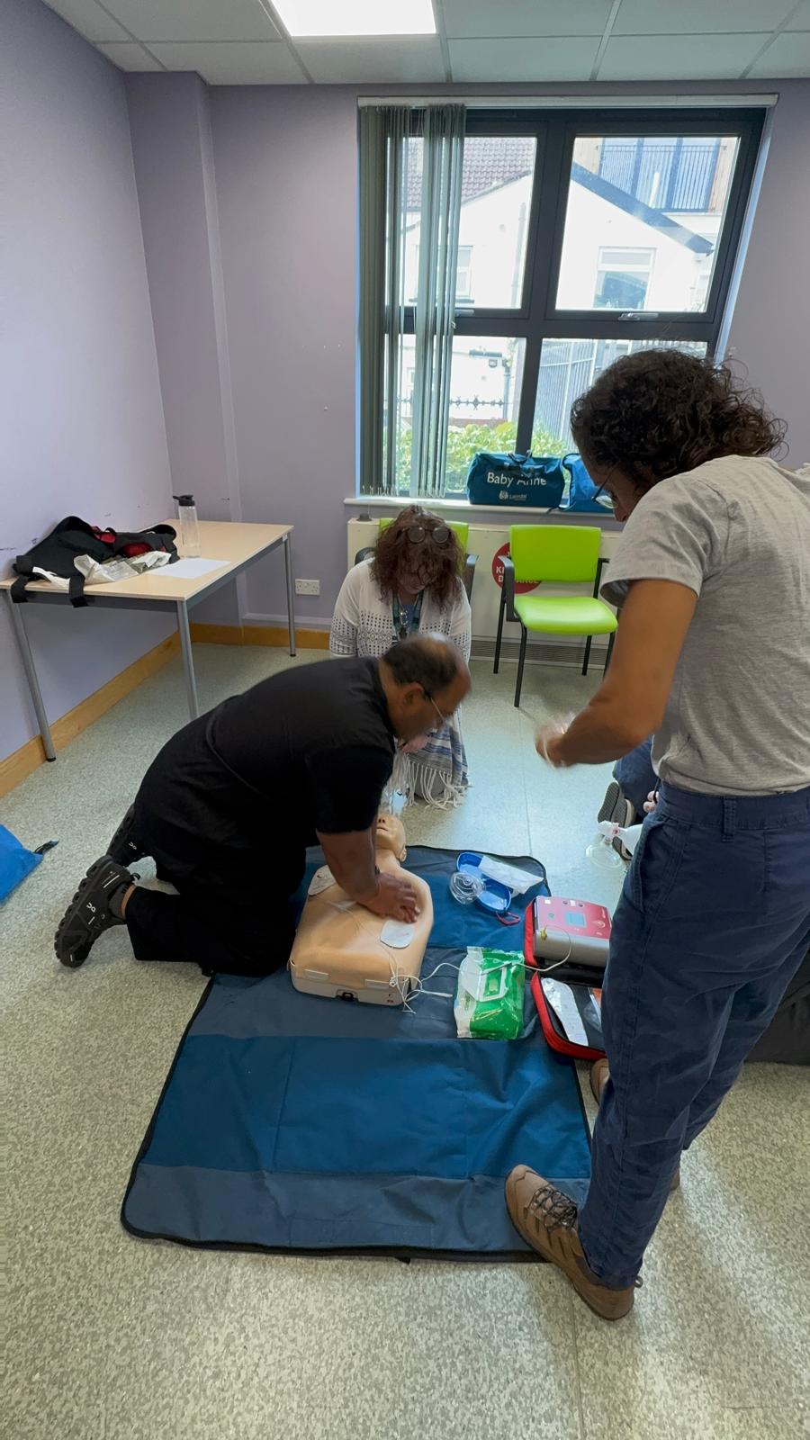 Healthcare professionals practising CPR during a Nursing Fundamentals training session